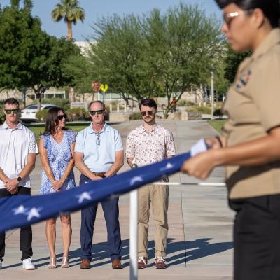 Richard Cracraft (second from left), stands with his wife, Laurie, and their two sons, while being presented with a flag honoring his 38 years of federal service during a ceremony July 11 in China Lake, Calif. 