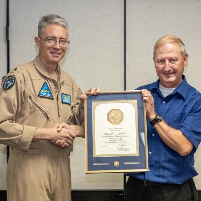 Ken Ewbank, right, poses with Rear Adm. Keith Hash, Naval Air Warfare Center Weapons Division Commander, after receiving his 45-year Length-of-Service Award in a ceremony July 14 in China Lake, California. (U.S. Navy photo by Ryan Smith)