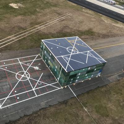 A helicopter’s-eye view of the Elevated Fixed Platform (EFP), a test platform constructed on a disused taxiway at Naval Air Station Patuxent River for testing recirculation effects on the V-22 Osprey. Upon completion of those tests, two U.S. Naval Test Pilot School instructors seized the opportunity before the EFP was dismantled to conduct a flight test program that they hope will lead to a better understanding of how helicopters behave when landing on and taking off from ships at sea, rooftop platforms, an