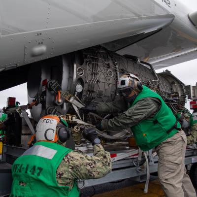 Strike Fighter Squadron (VFA) 147 load an F-35C engine module onto a CMV-22B Osprey with Fleet Logistics Multi-Mission Squadron (VRM) 30