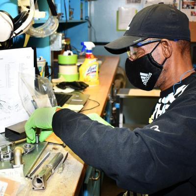 Man sorts parts on workbench