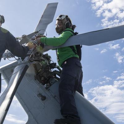 Maintenance on the tail rotor of a MH-60S Seahawk helicopter