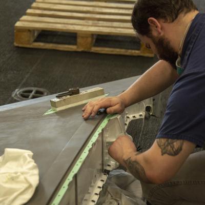Aircraft mechanic performs cleans bearing on F-35B tail