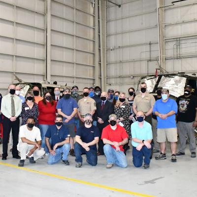 Group shot in front of H-1 helicopter airframe