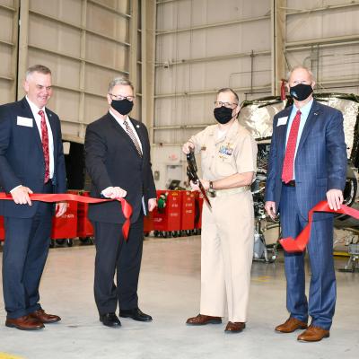 Navy captain and local dignitaries cut ribbon during opening ceremony