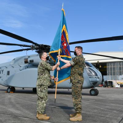 Outgoing Fleet Readiness Center East commander passes guidon to incoming commanding officer