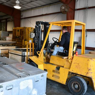 Forklift removes parts from warehouse