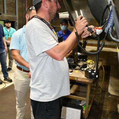 Man manually cleans fiber optic cables