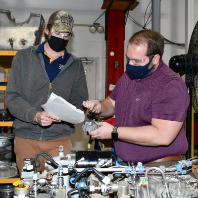 Engineers examine APU filter