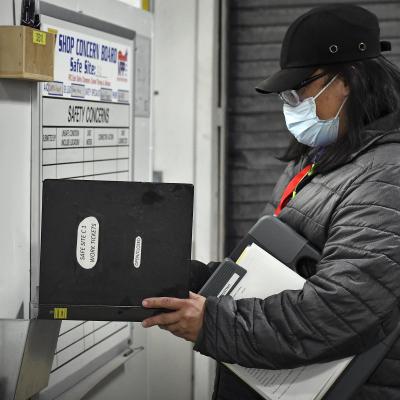 Aquiles Faustino, a safety specialist at Fleet Readiness Center East (FRCE), conducts an inspection of a safe site board. FRCE closed out calendar year 2021 with the lowest number of Occupational Safety and Health Administration (OSHA) recordable mishaps in the depot’s history.