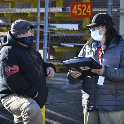 Aquiles Faustino, a safety specialist at Fleet Readiness Center East (FRCE), speaks with Samuel Foreman, an electrical equipment repairer at FRCE, during a safety site survey. 