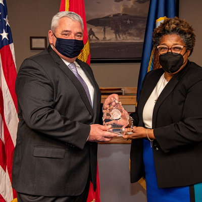 Deputy Assistant Secretary of Defense for Product Support Lisa P. Smith (right) presents Byrd with the 2021 Office of the Secretary of Defense for Acquisition and Sustainment PSM of the Year (Major Defense Acquisition Program, Acquisition Category 1) award. 
