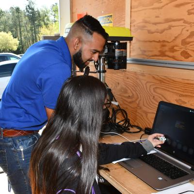Engineer helps student program computer