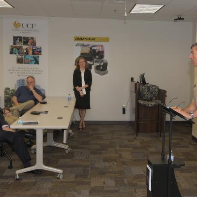 Captain speaking at podium in classroom.
