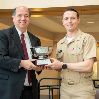 Cmdr. Dan Button accepts NAVAIR Commander's Award from Tom Rudowsky, NAVAIR deputy commander.