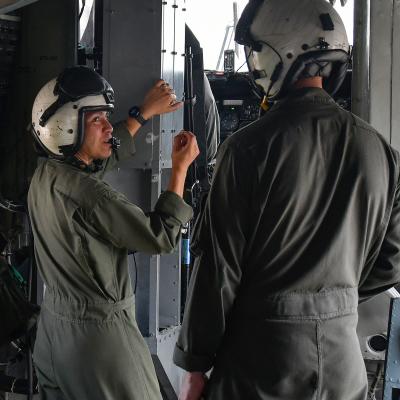 Maj. Brittany Fayos, left, Military Aircraft Production Deputy Director and CH/MH-53 pilot at Fleet Readiness Center East (FRCE), talks with a crew chief prior to conducting a functional check flight inspection of a CH-53 Sea Stallion helicopter. 