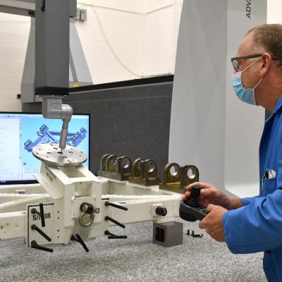Ben Pate, operations manager at Fleet Readiness Center East’s (FRCE) Precision Measurement Center, operates a coordinate measuring machine (CMM). A CMM is a device that measures the geometry of physical objects by sensing points on the surface of the object with a probe. 
