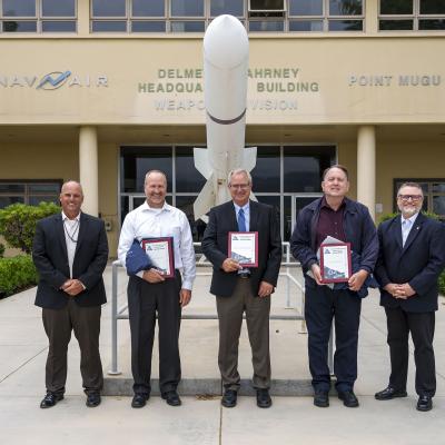 NAWCWD Fellow inductees from Point Mugu pose for a picture with Dan Carreño, NAWCWD executive director, left, and Tom Dowd, NAWCWD’s Ranges, Target Operations, Instrumentation and Labs Group director, right, after the Fellows induction ceremony on July 13. (U.S. Navy photo by Rob Grabendike)