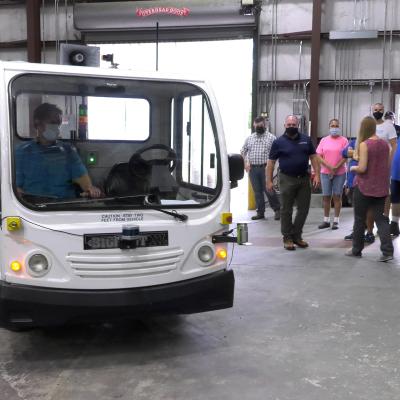 Driverless vehicle turns down aisle in warehouse