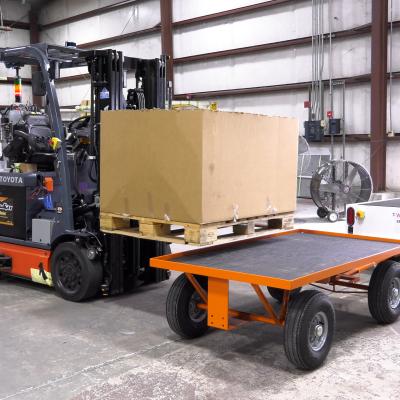 Forklift loads crate on trailer