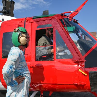 Aircraft maintainer and pilot discuss performance of UH-1N helicopter after functional check flight