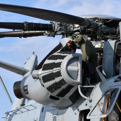 Fleet Readiness Center East (FRCE) Rotary Wing Division deputy and CH-53 pilot Maj. Brittany Fayos, right, and Alex Talley, an aircraft mechanic at FRCE, conduct a functional check flight inspection prior to the delivery of a recently overhauled CH-53 helicopter to the fleet.