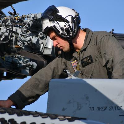Staff Sgt. Matthew Hotelling, H-53 Military Branch deputy and CH-53 crew chief at Fleet Readiness Center East (FRCE), conducts a functional check flight inspection prior to the delivery of a recently overhauled CH-53 helicopter to the fleet.