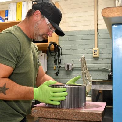Fleet Readiness Center East (FRCE) Bearing Shop work leader Justin Parrish prepares a bearing for cleaning. FRCE’s Bearing Shop refurbishes hundreds of bearings each week, turning out several thousand each month. The shop works with nearly 5,000 different part numbers ranging from bearings used on CH-53 helicopters to those used in military hovercraft variants. 