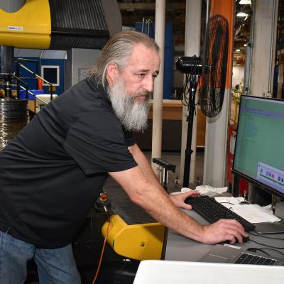 John Stafford, a machinist at Fleet Readiness Center East’s Repair Machine Shop, takes precise measurements on a T64 engine component. It is not uncommon for the machinists working in the shop to deal with tolerances as low as one ten thousandth of an inch. The Repair Machine Shop supports the depot’s aircraft production areas by reconditioning and refurbishing a vast array of parts and components. 