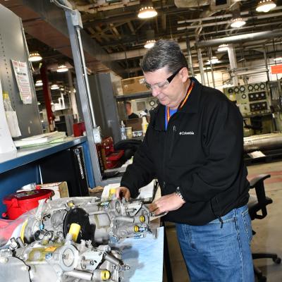 Quality assurance specialist examines completed fuel control unit