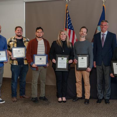 NAWCWD graduates for NLDP and JLDP who attended graduation at Point Mugu pose with Pat Schuett, NAWCWD product director for Air Wing Integration & Interoperability/EW Effects, second right, on March 29. (U.S. Navy Photo by Rob Grabendike)
