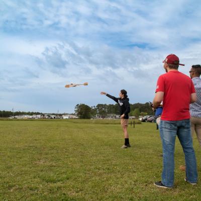 A student from Havelock High School launches an unmanned aerial vehicle (UAV) during the 2023 Ultimate Unmanned Aerial Vehicle Competition, held April 22 in Newport. Students representing eastern North Carolina high schools designed UAVs for the competition, which evaluated the speed and maneuverability of their creations. 