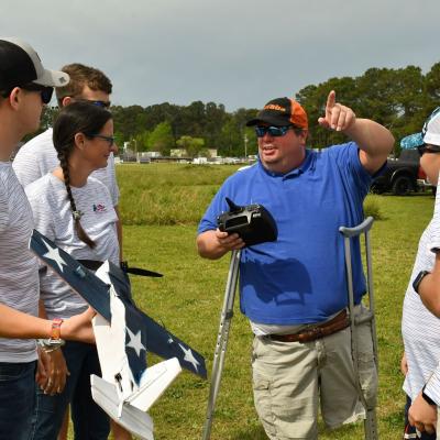 Elton Fairless, a senior engineer with Fleet Readiness Center East’s (FRCE) Unmanned Aerial Systems Fleet Support Team, prepares to test an unmanned aerial vehicle (UAV) designed by students from West Carteret High School during the 2023 Ultimate Unmanned Aerial Vehicle Competition held April 22 in Newport. Students representing eastern North Carolina high schools designed UAVs for the competition, which evaluated the speed and maneuverability of their creations. 