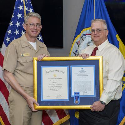 Russell Peterson, right, poses with Rear Adm. Keith Hash, NAWCWD commander, after receiving his Navy Meritorious Civilian Service Award on July 12 in Point Mugu, California. (U.S. Navy photo by Rob Grabendike)