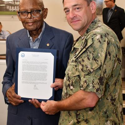 Fleet Readiness Center East (FRCE) Commanding Officer Capt. James M. Belmont recognized Freddie Dawkins, a pneudraulics systems mechanic at the depot, during a retirement ceremony honoring Dawkins’ 70 years of combined military and civilian service. 