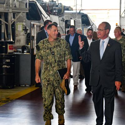 Fleet Readiness Center East (FRCE) Commanding Officer Capt. James M. Belmont, left, briefs U.S. Rep. Greg Murphy on the depot’s H-53 heavy-lift helicopter line during Murphy’s visit to the facility Aug. 14. FRCE hosted Murphy, who represents North Carolina’s 3rd Congressional District in the U.S. House of Representatives, for briefings and a tour focused on the depot’s expanding workload and future capabilities, including enhanced support of the fifth-generation F-35 Lightning II aircraft. 