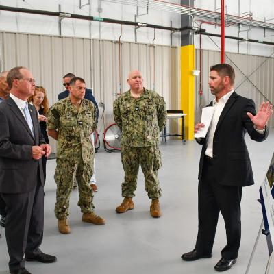Fleet Readiness Center East (FRCE) Business Development and Workload Planning Branch Head Matt McCann, right, briefs U.S. Rep. Greg Murphy on the depot’s future F-35 vertical lift fan testing and processing facilities during Murphy’s visit to the facility Aug. 14. 