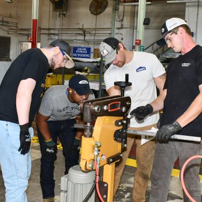 Artisans inspect equipment.