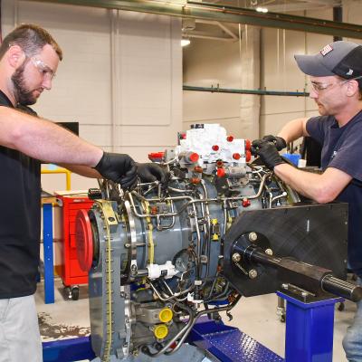 Steven Murray, left, and Dakota Martin, aircraft engine mechanics at Fleet Readiness Center East (FRCE, begin disassembly of a lift fan clutch for the F-35B Lightning II aircraft. FRCE personnel became the first within the Department of Defense (DoD) to perform a successful assembly of this component outside of Rolls Royce’s LiftWorks facility in Indianapolis. 