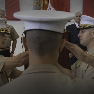 Two marines hold flag in change of command ceremony