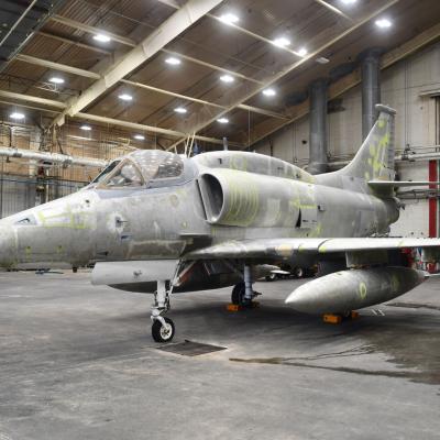 Gray-looking aircraft in a large building 