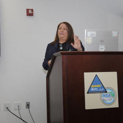 Woman speaking at podium.
