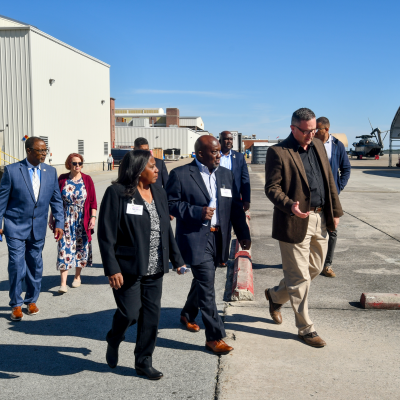 Eight individuals walking outside 