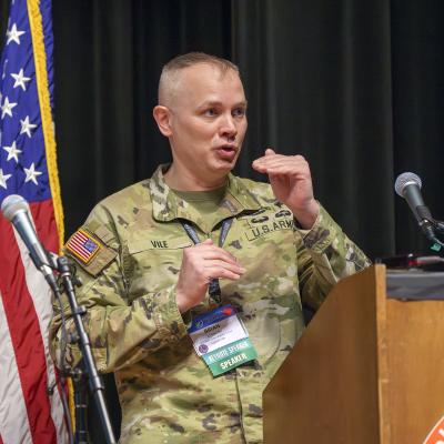 Brig. Gen. Brian Vile, Commandant, United States Army Cyber Warfare School, delivers a keynote address during the Collaborative EW Symposium on March 13 in Point Mugu, California. (U.S. Navy photo by Rob Grabendike)