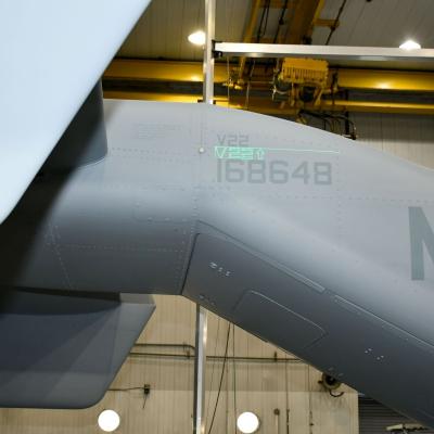 Tail end of a V-22 aircraft with green laser projected onto it