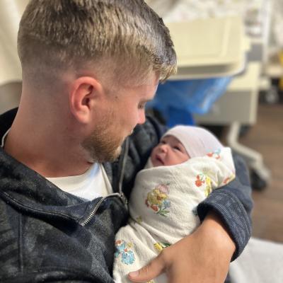 Man holding a newborn baby 