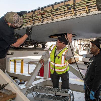 Three men discussing in industrial workplace