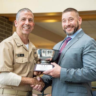 Vice Adm. Carl Chebi presents Chris Albright with the NAVAIR Commander’s Award for Most Impactful Supervisor
