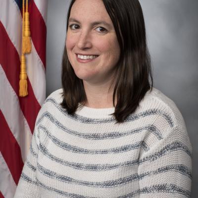 Portrait of female in front of American flag 