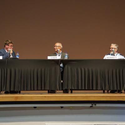 Royal Air Force Air Commodore Steve Berry (left), commandant of the United Kingdom's Air and Space Warfare Centre; Dr. Andrew Chen (center), chief engineer of spectrum dominance at Naval Air Warfare Center Weapons Division; and Royal Australian Air Force Wing Commander Joseph Bennett (right) of the Air Warfare Centre participate in an international panel discussion at Naval Base Ventura County Point Mugu, March 11, 2026. 